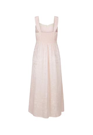 a-light-pink-sleeveless-midi-dress-with-a-smocked-bodice-wide-shoulder-straps-and-a-subtle-tonal-floral-jacquard-pattern-shown-against-a-plain-white-background